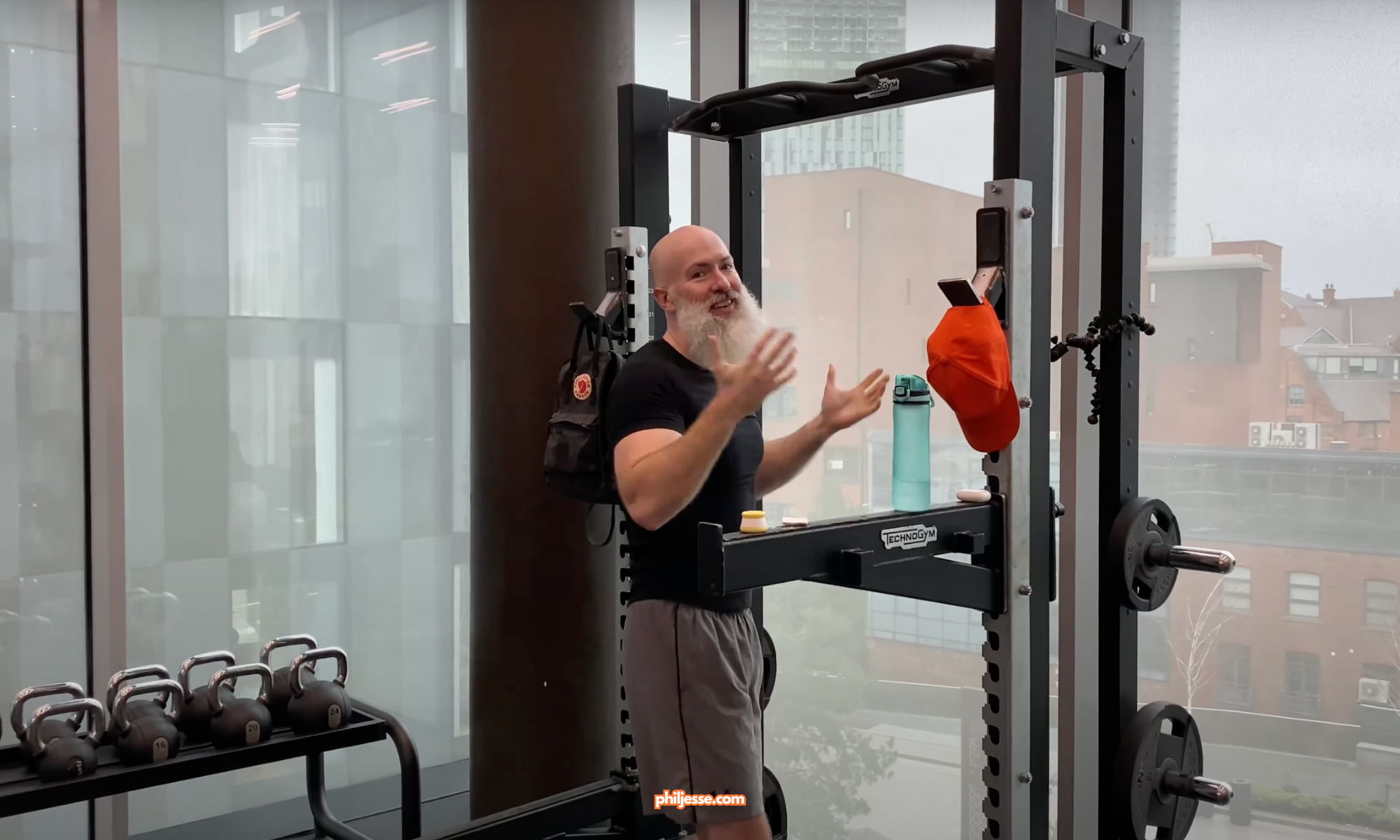 Phil Jessé celebrates completing his 100,000th pull-up at Deansgate Square, marking a significant achievement in his fitness journey.