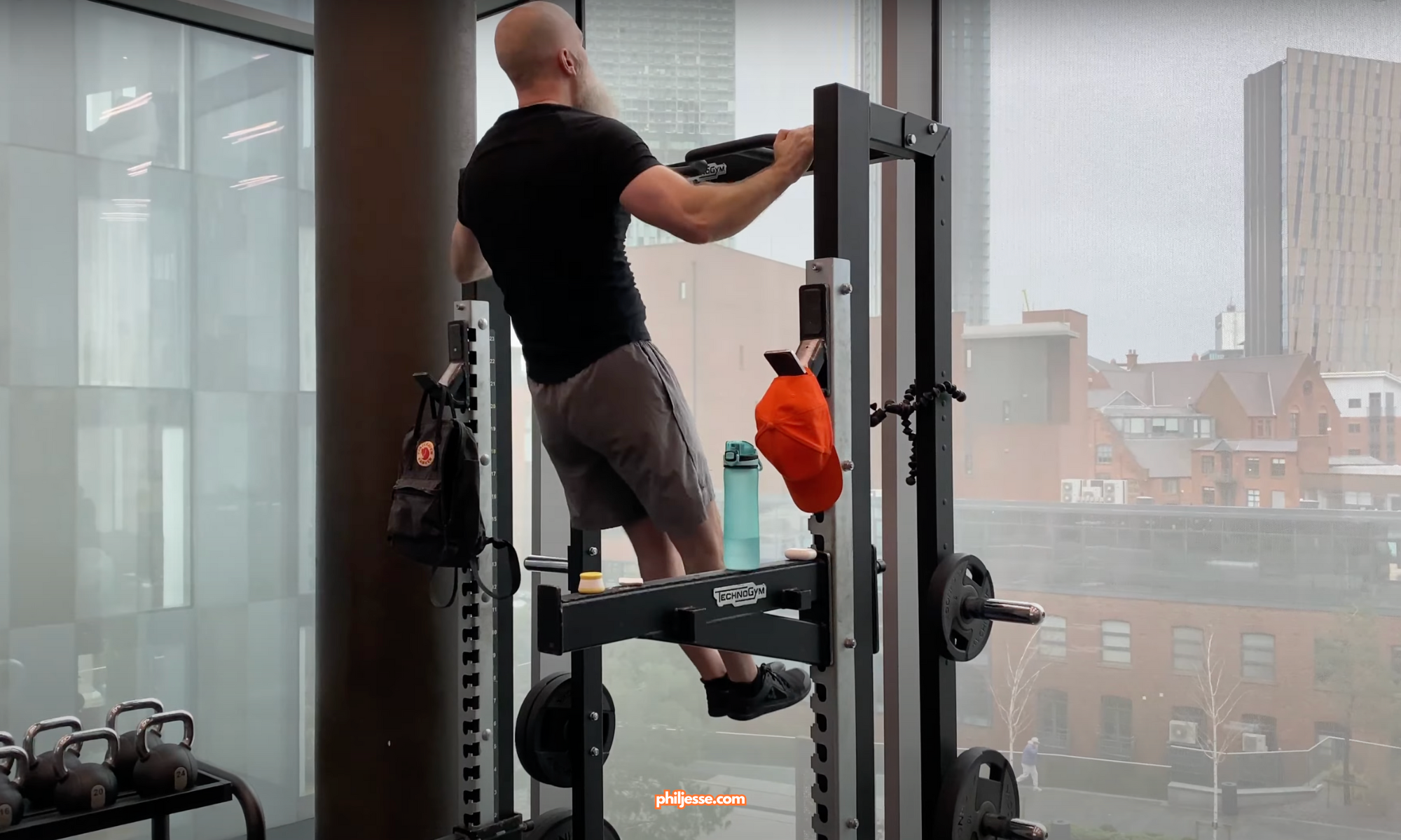 Phil Jessé completes his final pull-ups at Deansgate Square, marking the end of his 100,000 pull-up challenge.