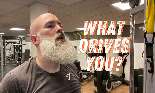 Performance coach Phil Jessé with determined expression and text overlay "What Drives YOU?"